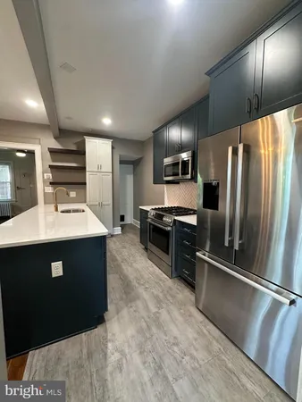 a kitchen with refrigerator cabinets and furniture