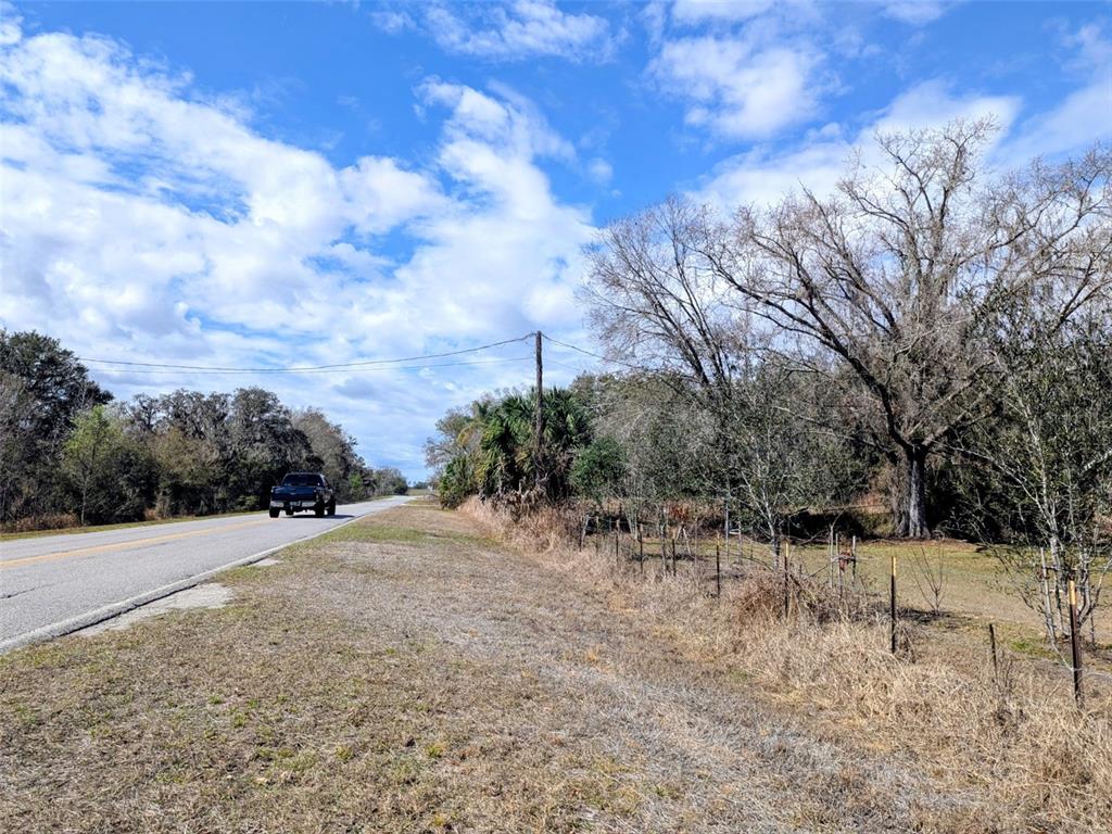 1142 Doc Coil Road Bowling Green, FL 33834 - Photo 13 of 27 a view of open space with a house in the background