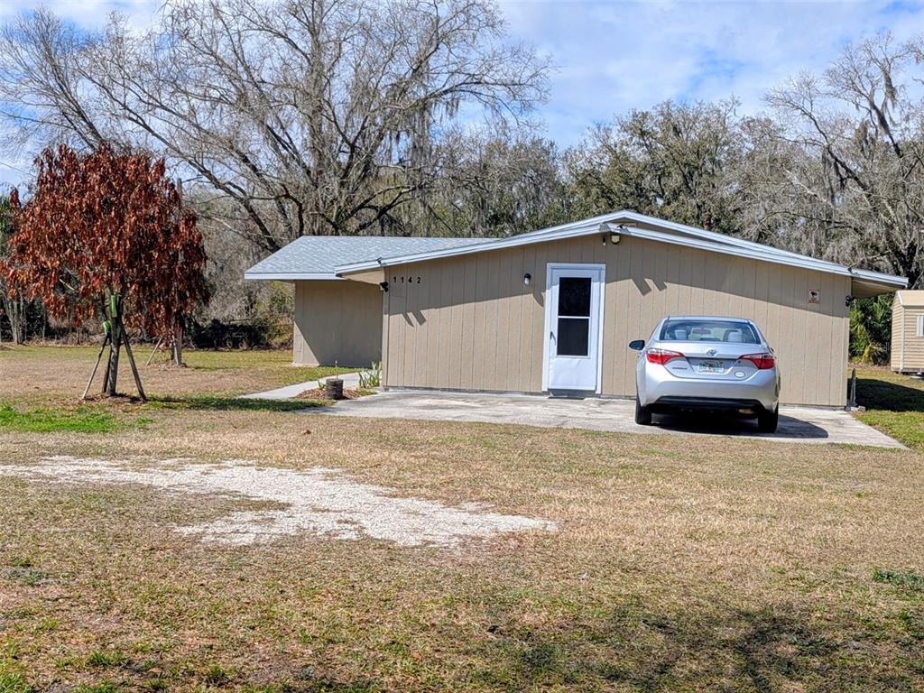 1142 Doc Coil Road Bowling Green, FL 33834 - Photo 2 of 27 a front view of a house with a yard