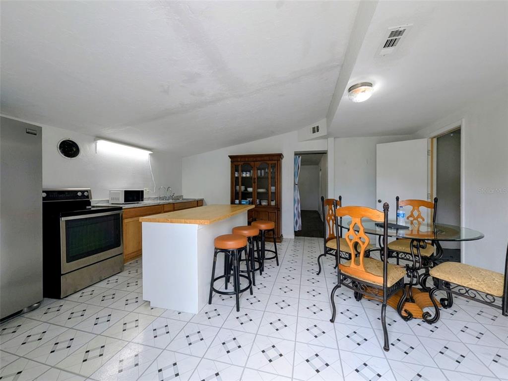 1142 Doc Coil Road Bowling Green, FL 33834 - Photo 4 of 27 a kitchen with stainless steel appliances kitchen island granite countertop a sink and cabinets