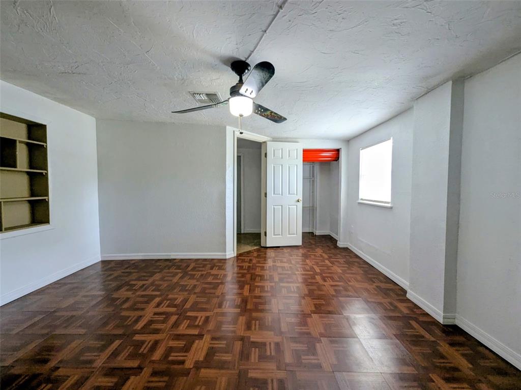 1142 Doc Coil Road Bowling Green, FL 33834 - Photo 7 of 27 a view of an empty room with window and wooden floor