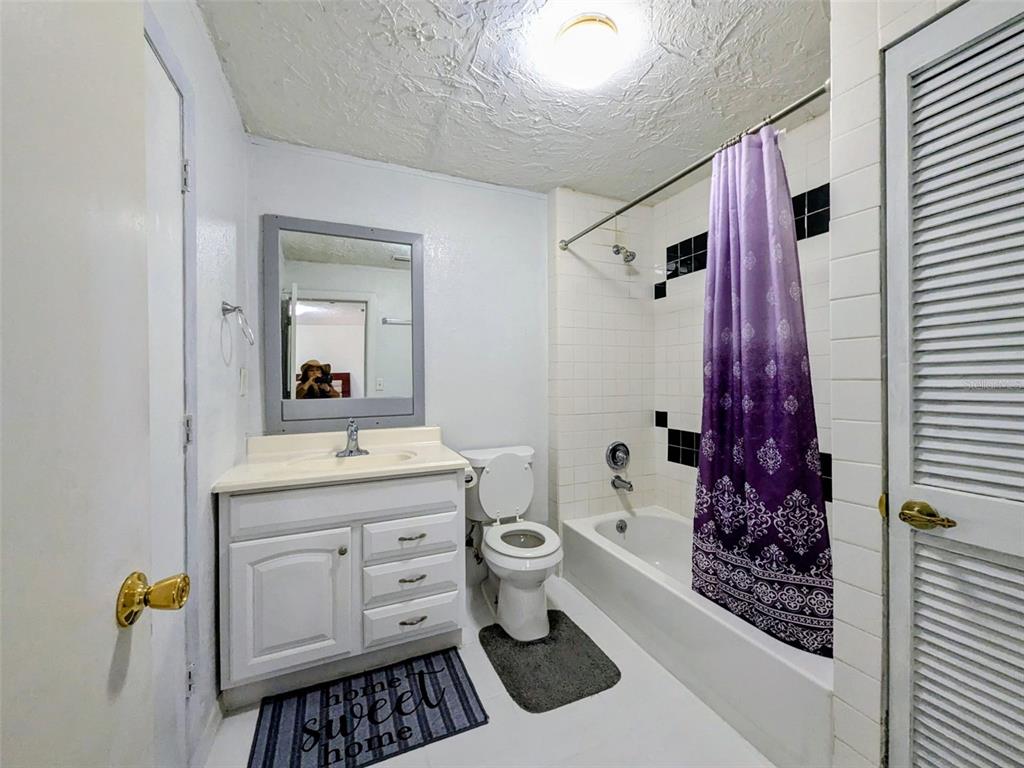 1142 Doc Coil Road Bowling Green, FL 33834 - Photo 9 of 27 a bathroom with a granite countertop sink a toilet and shower