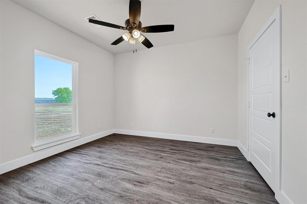 436 Dixie Road Whitesboro, TX 76273 - Photo 25 of 33 wooden floor in an empty room with a window