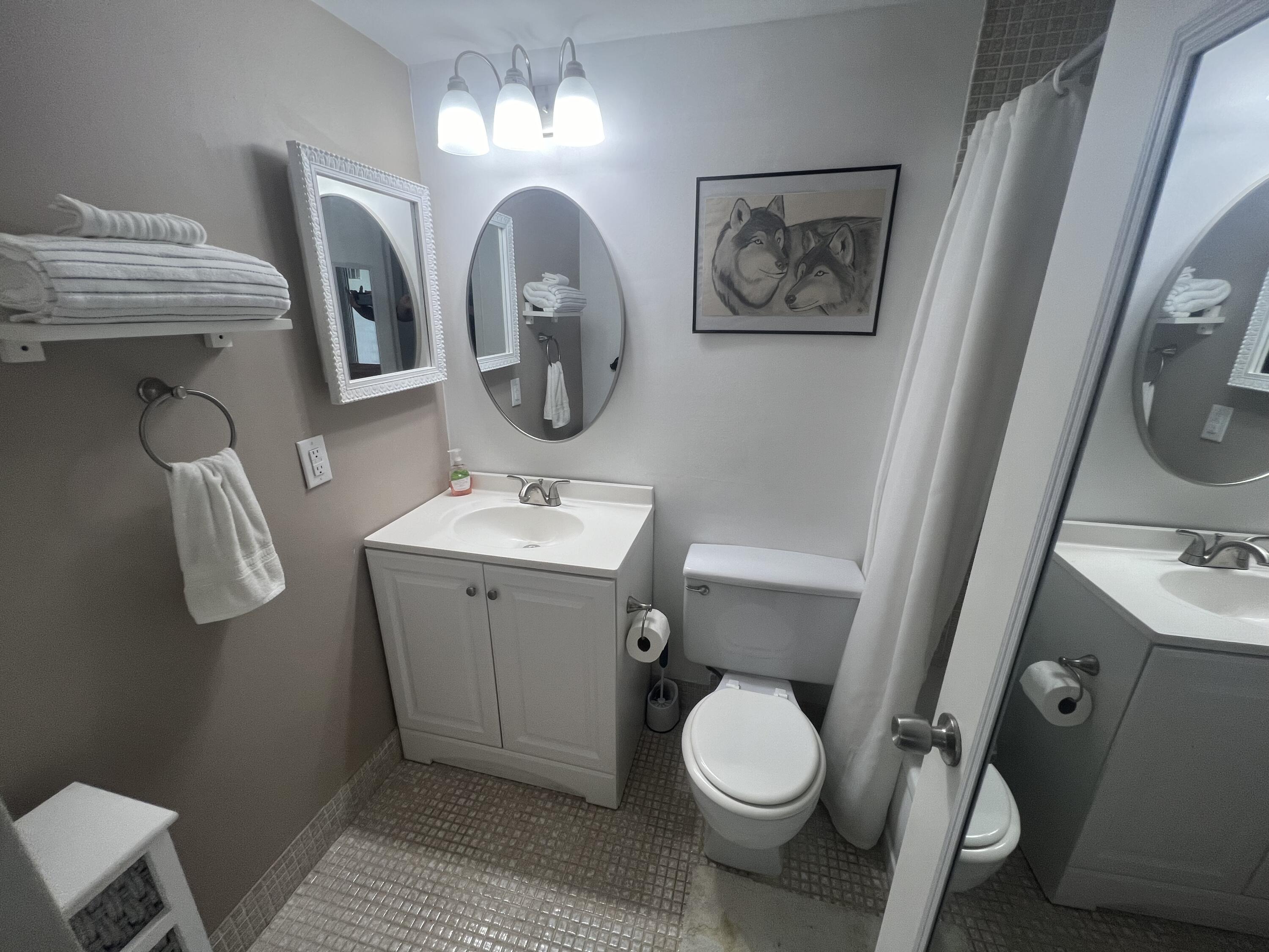 79 Dorset B Boca Raton, FL 33434 - Photo 11 of 12 a bathroom with a toilet sink and mirror