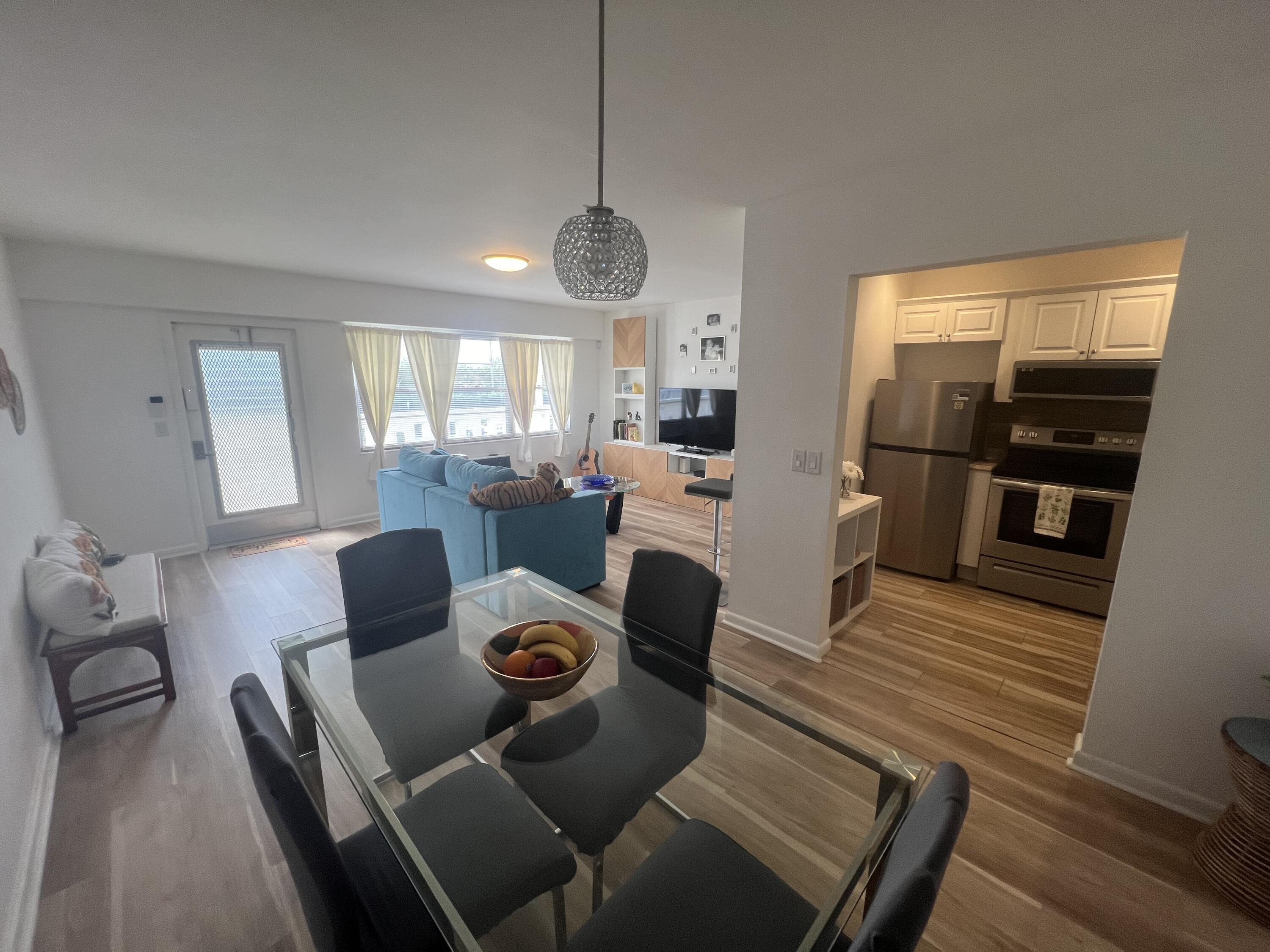79 Dorset B Boca Raton, FL 33434 - Photo 6 of 12 a living room with furniture dining table wooden floor and a large window