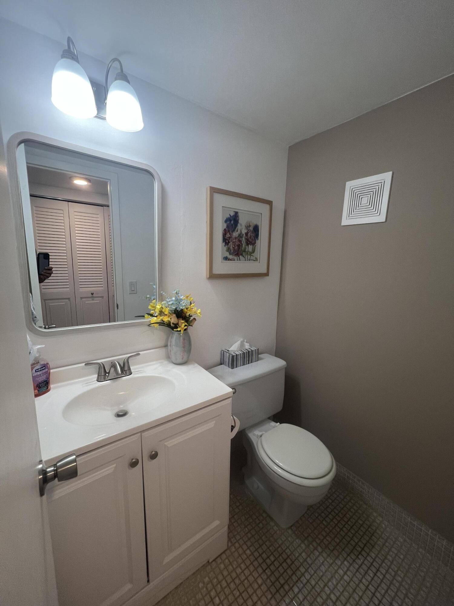 79 Dorset B Boca Raton, FL 33434 - Photo 7 of 12 a bathroom with a toilet sink and mirror