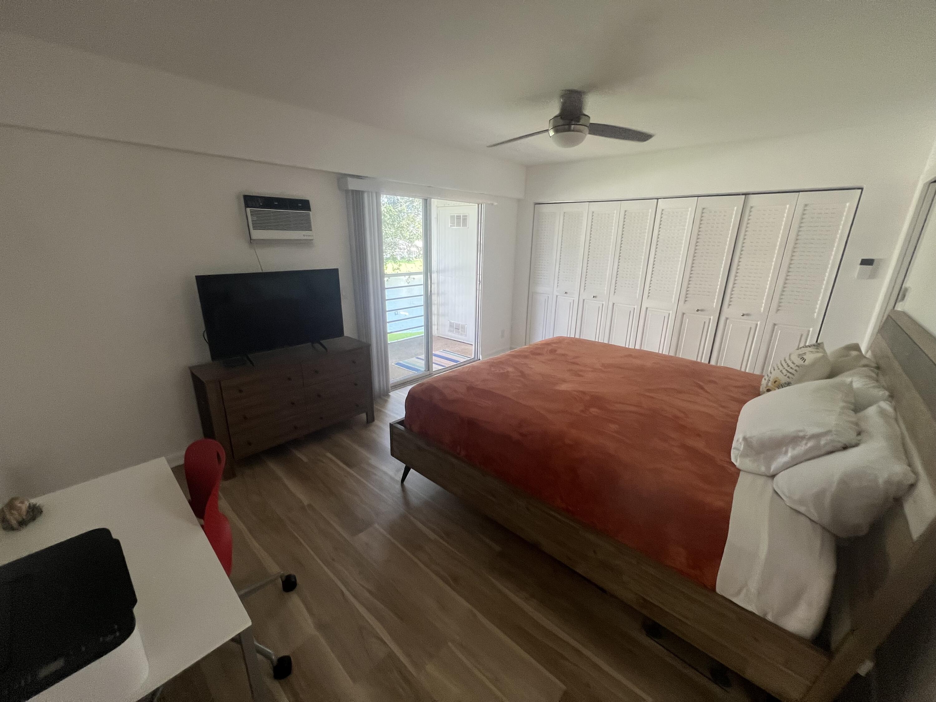 79 Dorset B Boca Raton, FL 33434 - Photo 9 of 12 a bedroom with a bed and a flat screen tv