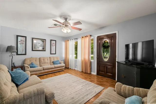 a kitchen with cabinets stainless steel appliances and wooden floor