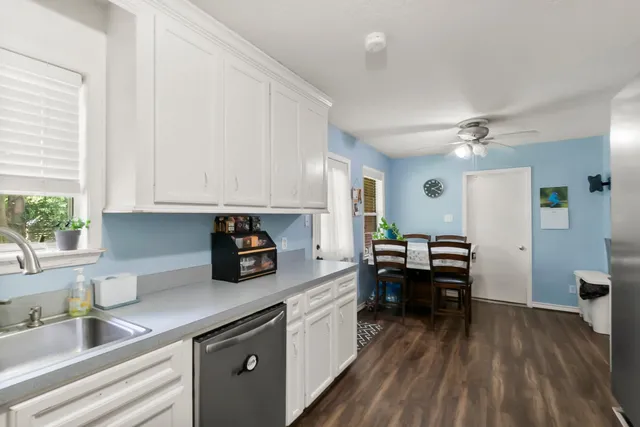 a bedroom with a bed and a flat tv screen on dresser