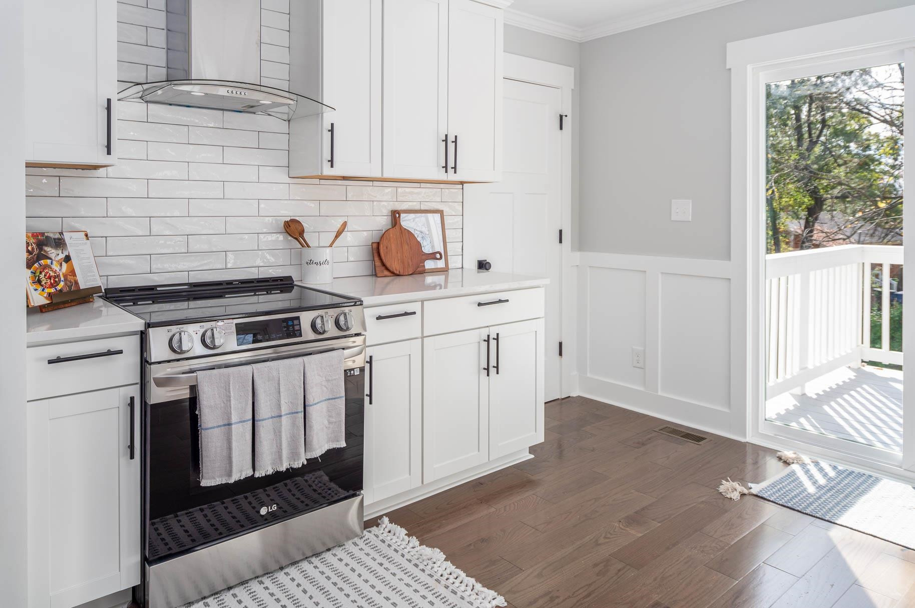 2108 Ramseur Street Raleigh, NC 27610 - Photo 14 of 26 a kitchen with a stove and white cabinets