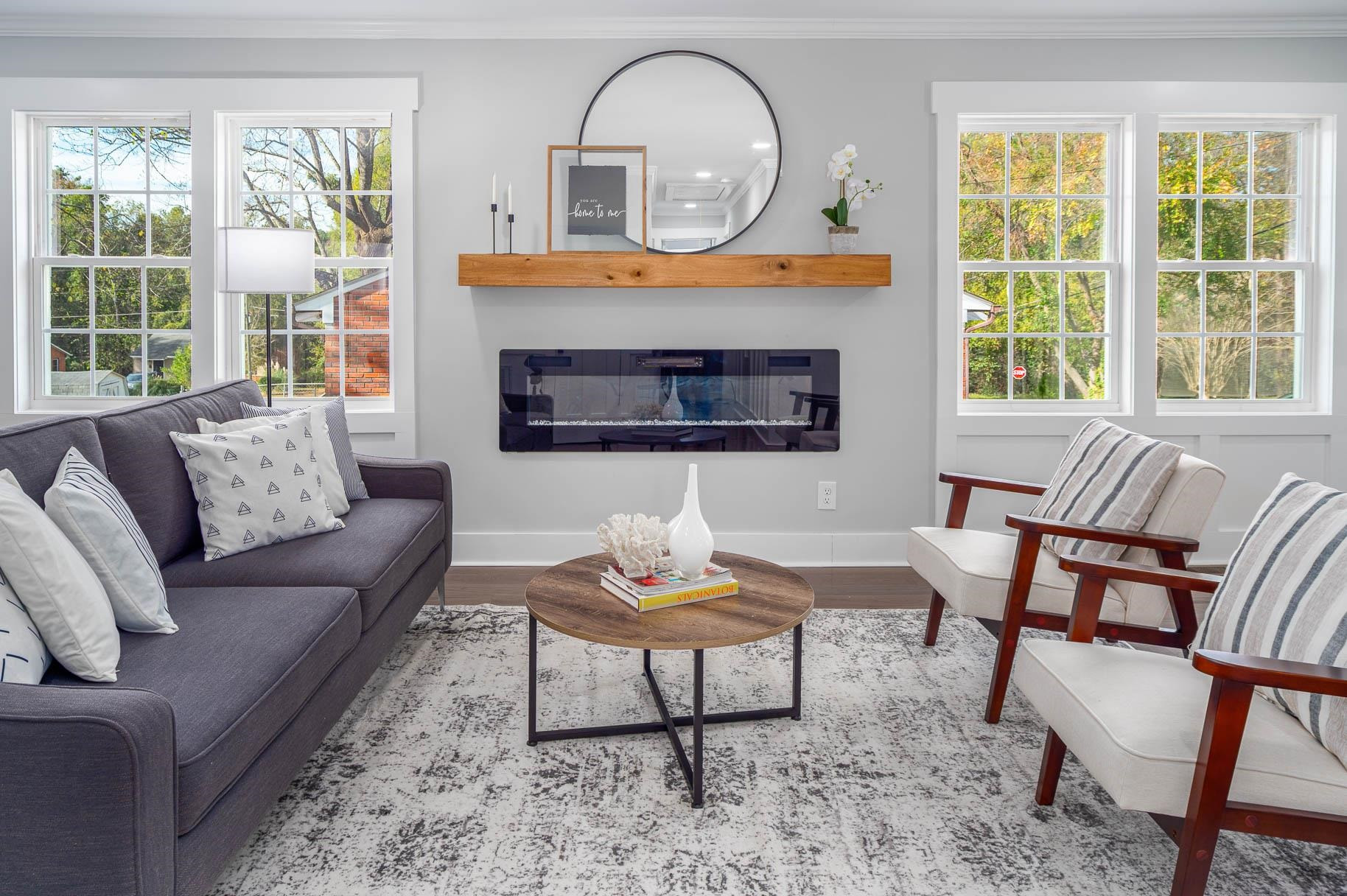 2108 Ramseur Street Raleigh, NC 27610 - Photo 6 of 26 a living room with furniture a rug a fireplace and a large window