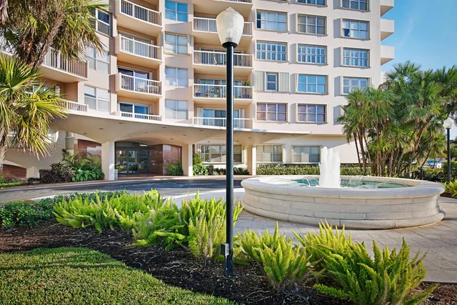a front view of a building with a garden