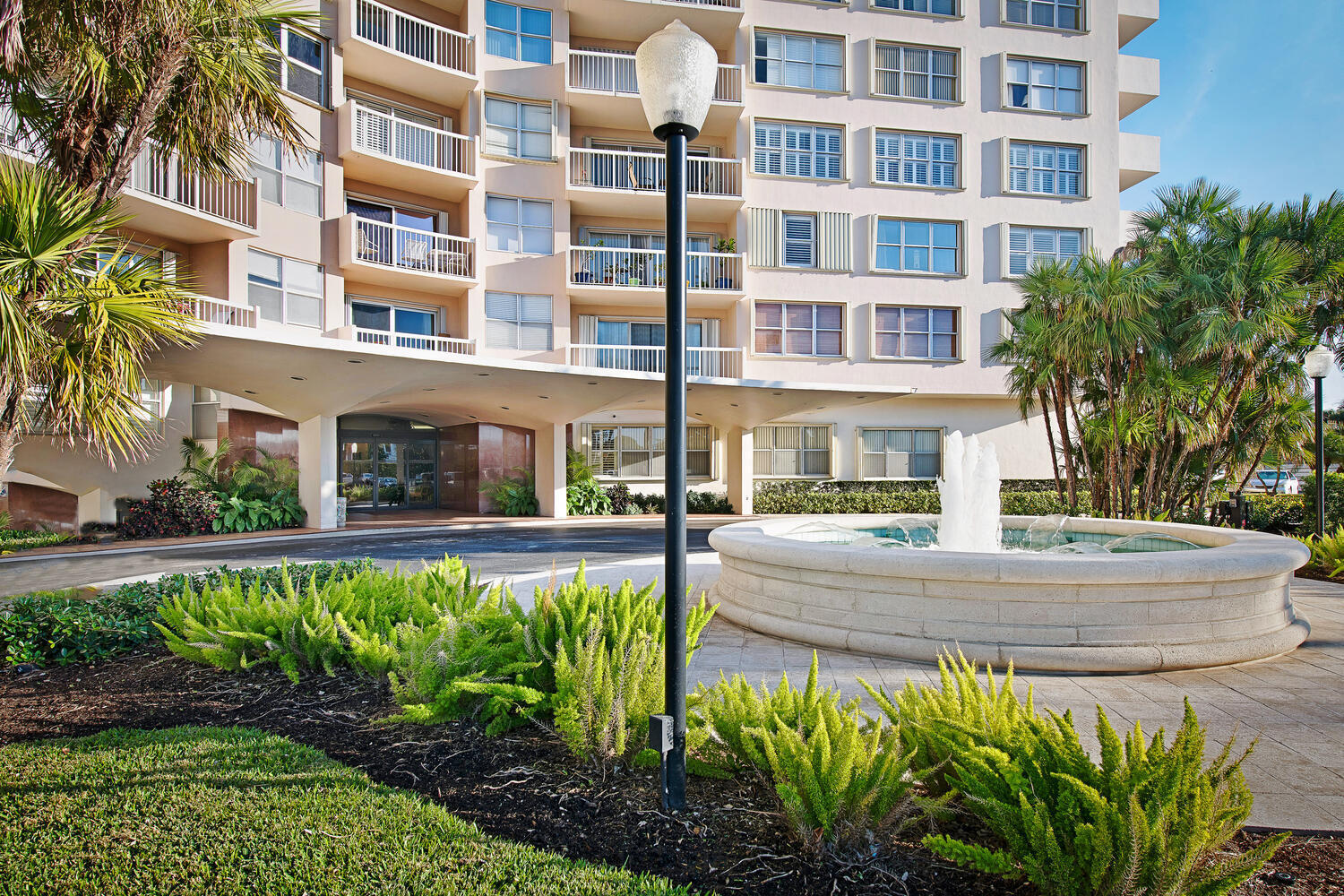 a front view of a building with a garden