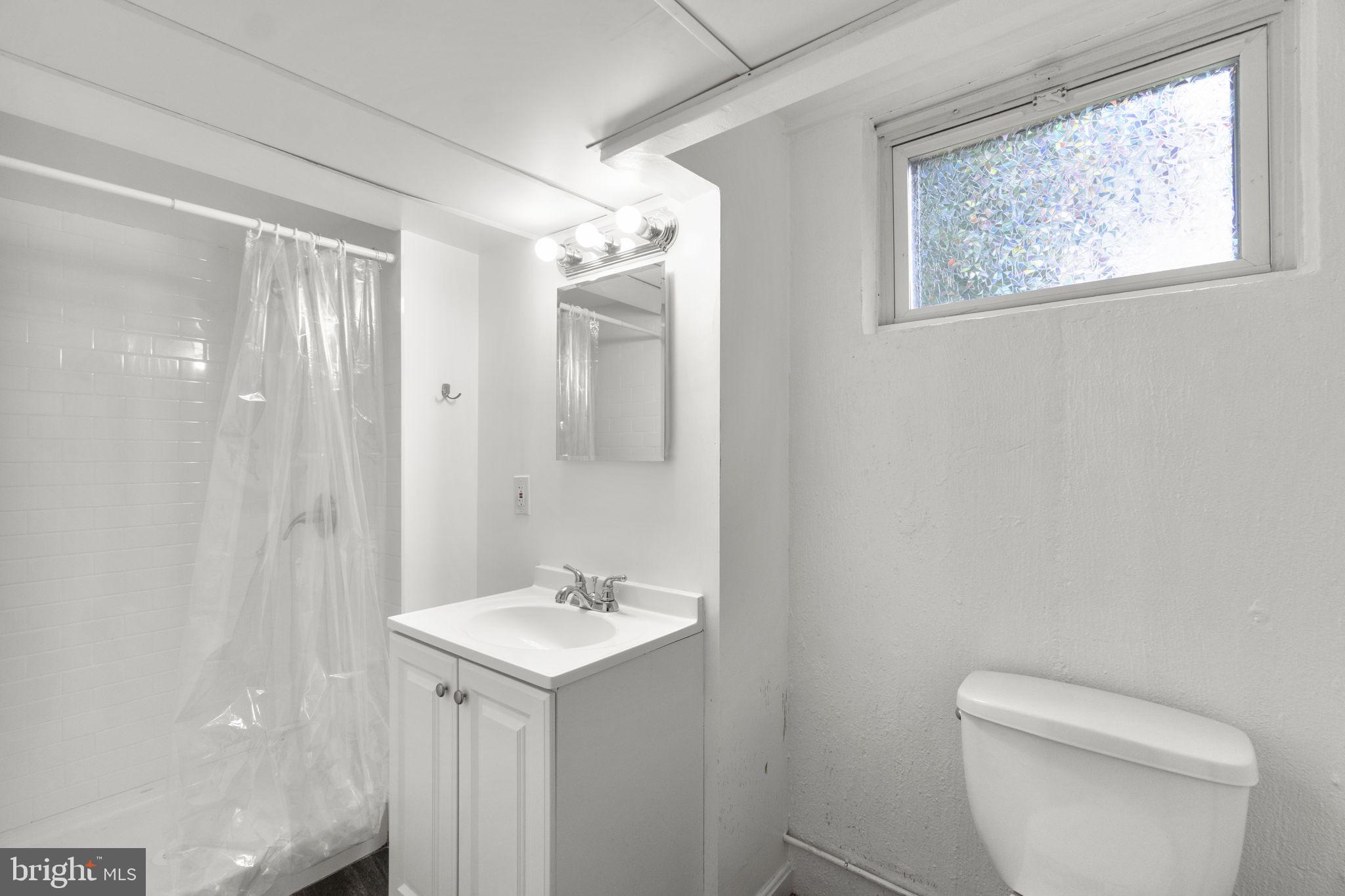 3658 Clifmar Road Baltimore, MD 21244 - Photo 34 of 43 a bathroom with a toilet sink and mirror