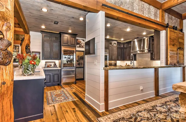 a kitchen with stainless steel appliances kitchen island granite countertop a refrigerator and a stove
