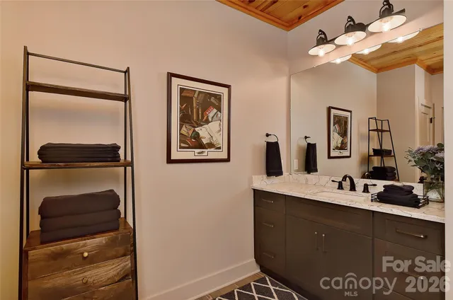 a bathroom with a sink mirror and vanity