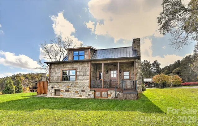 a view of a house with a yard and sitting area