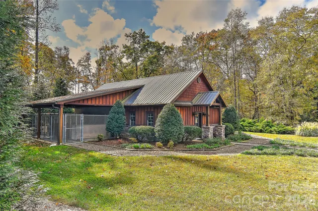 a front view of a house with a yard and lake view