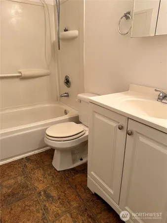a view of a room with wooden floor and furniture