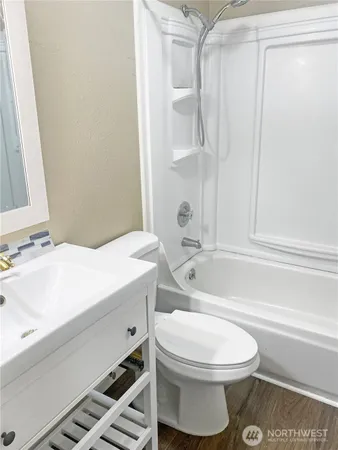 a bathroom with a toilet a sink and bathtub