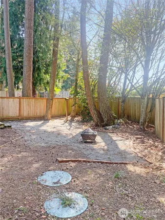 a backyard of a house with table and chairs