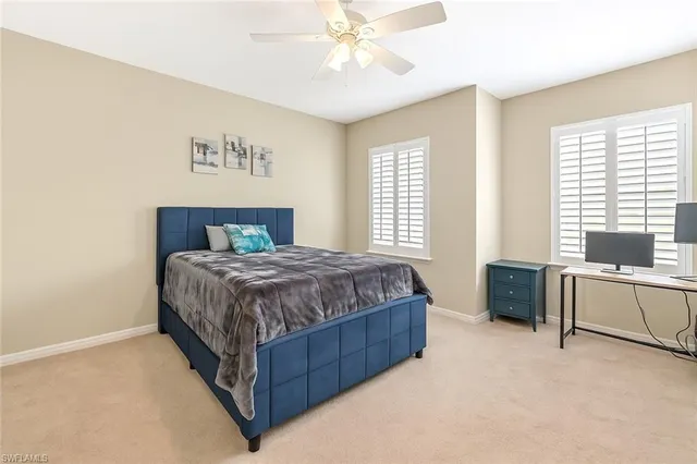 a spacious bedroom with a bed and a chandelier