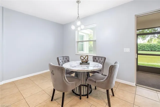 a view of a dining room with furniture and a window
