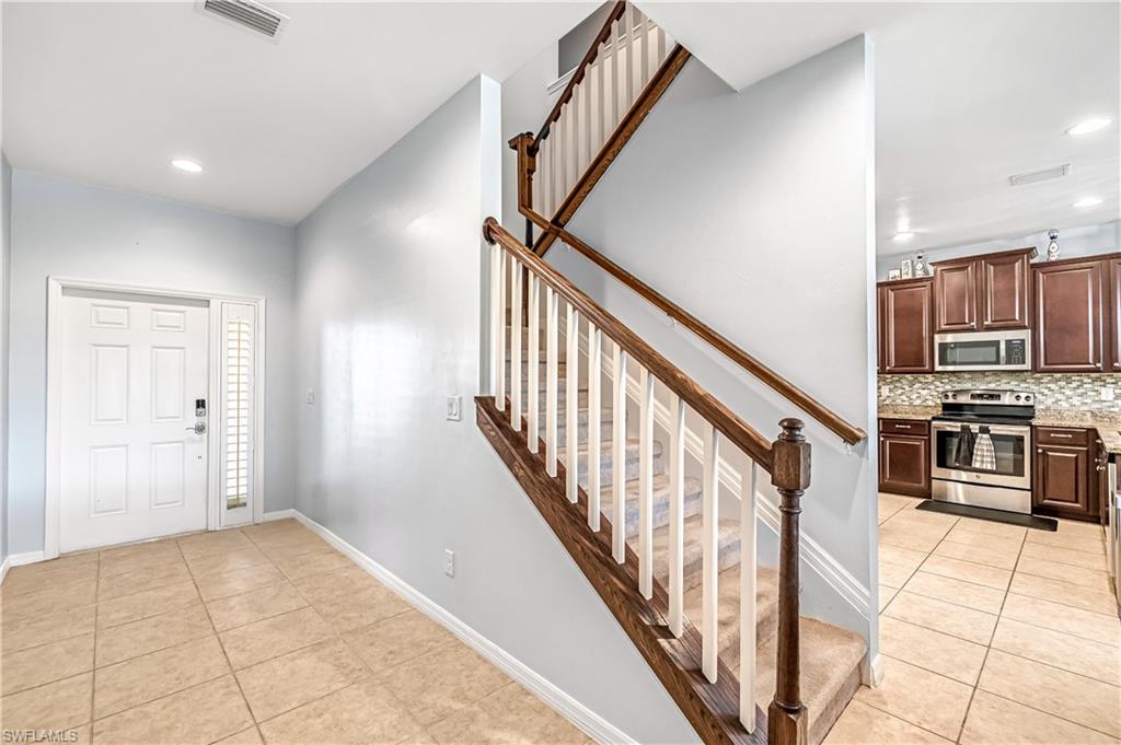 19550 Bowring Park Road, Unit 102 Fort Myers, FL 33967 - Photo 4 of 20 a view of a kitchen with an empty room and stairs