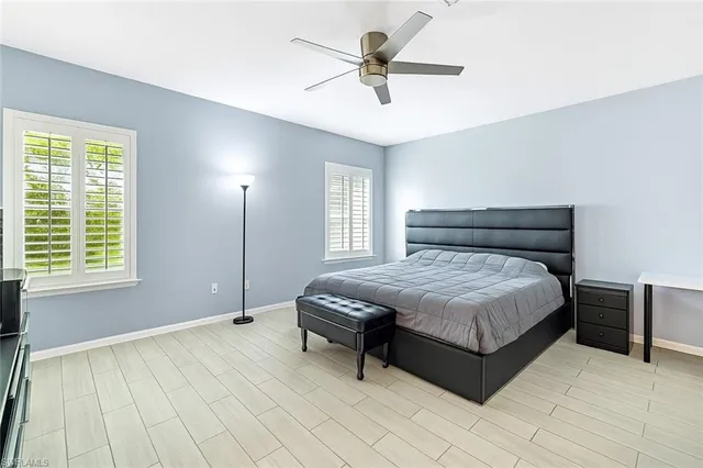 a spacious bedroom with a bed and a window