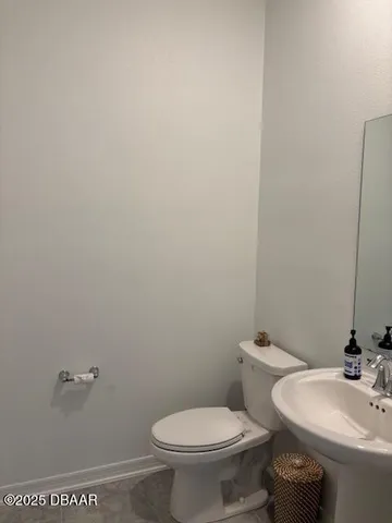 a white toilet sitting next to a bathroom sink