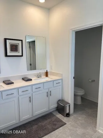 a spacious bathroom with a toilet sink and a mirror