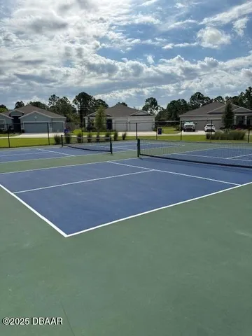 a view of an outdoor space and tennis court