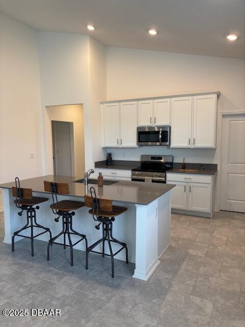 3966 Willowbrook Drive Edgewater, FL 32141 - Photo 5 of 20 a kitchen with stainless steel appliances a stove a sink a microwave a dining table and chairs