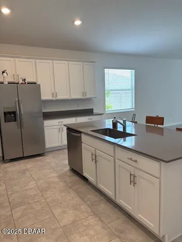 a kitchen with cabinets a sink and appliances