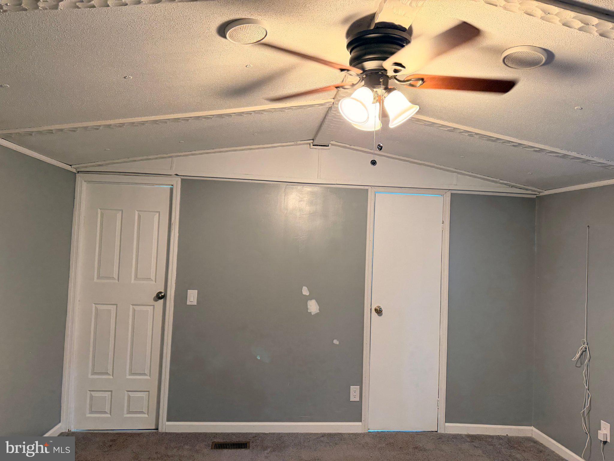 24 Carpenter Street, Unit 24 Dover, DE 19901 - Photo 4 of 27 Spacious room with modern ceiling fan.