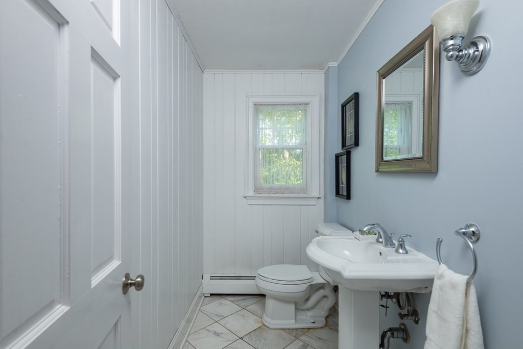 7 Longfellow Road Winchester, MA 01890 - Photo 22 of 42 a bathroom with a sink a toilet and a mirror