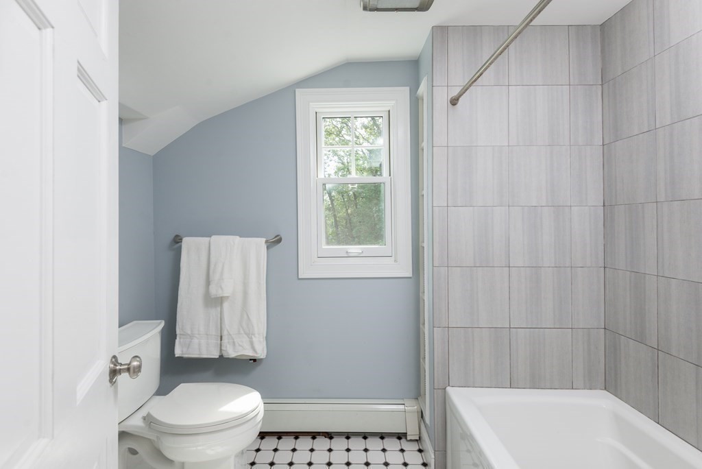 7 Longfellow Road Winchester, MA 01890 - Photo 27 of 42 a white toilet sitting next to a bath tub