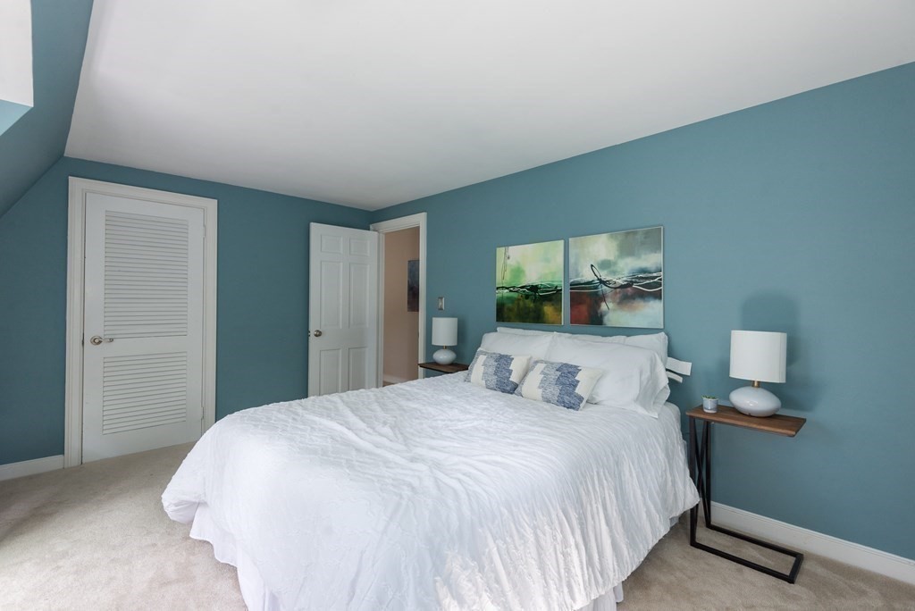 7 Longfellow Road Winchester, MA 01890 - Photo 29 of 42 a bedroom with a bed and a large mirror