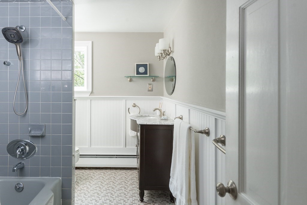 7 Longfellow Road Winchester, MA 01890 - Photo 32 of 42 a bathroom with a sink and mirror with bathtub
