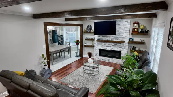 a living room with furniture fireplace and flat screen tv