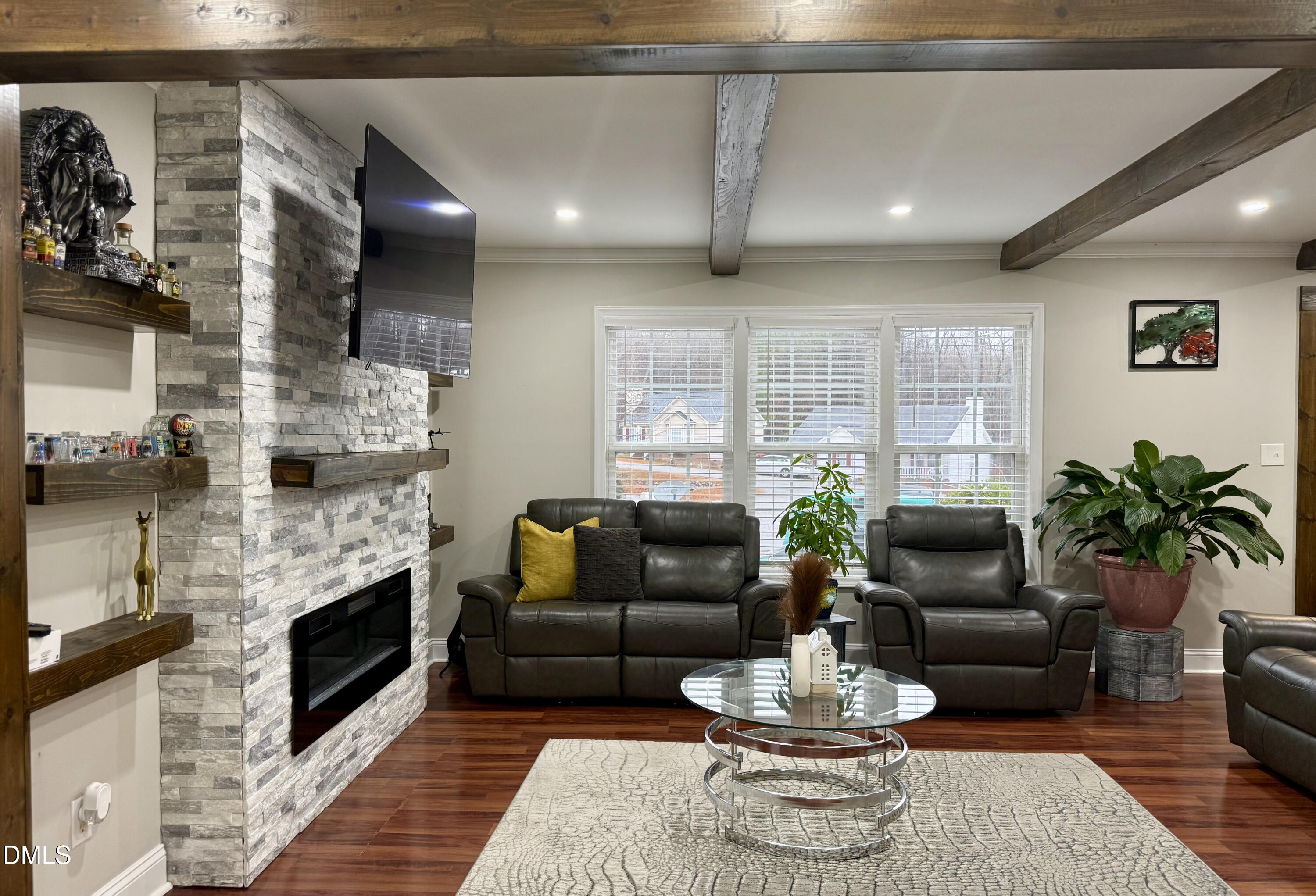 1020 Laurel Leaf Road Zebulon, NC 27597 - Photo 14 of 27 a living room with furniture a fireplace and a chandelier