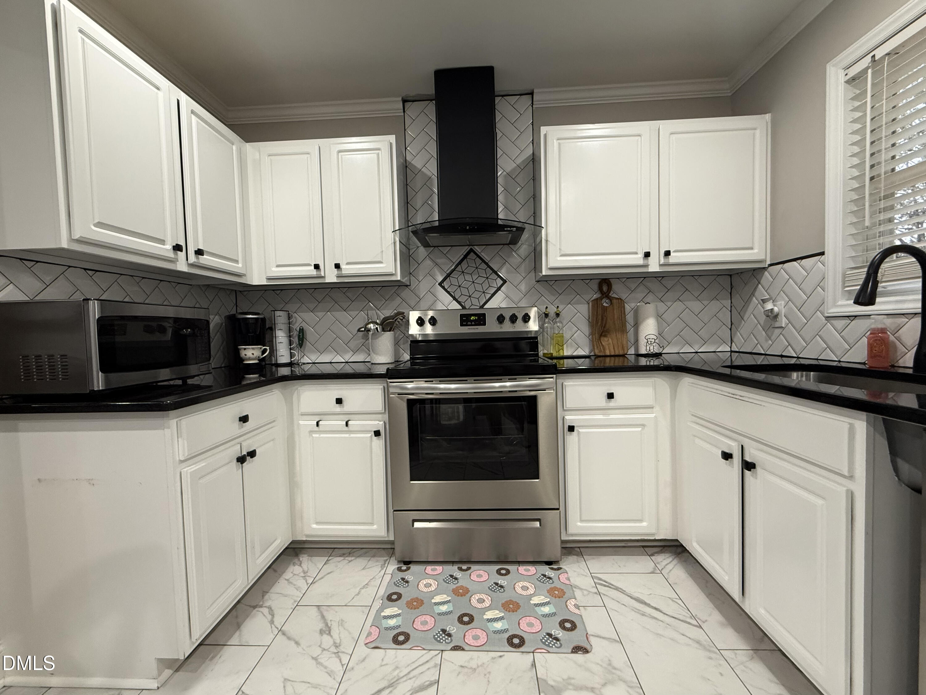 1020 Laurel Leaf Road Zebulon, NC 27597 - Photo 17 of 27 a kitchen with stainless steel appliances granite countertop white cabinets sink and stove