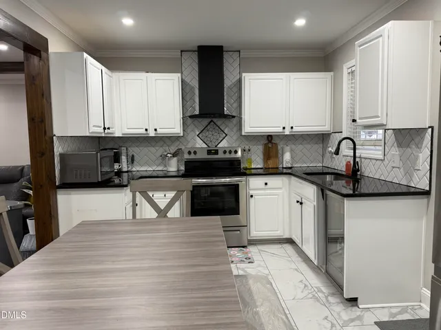 a dining hall with stainless steel appliances kitchen island granite countertop a dining table and chairs