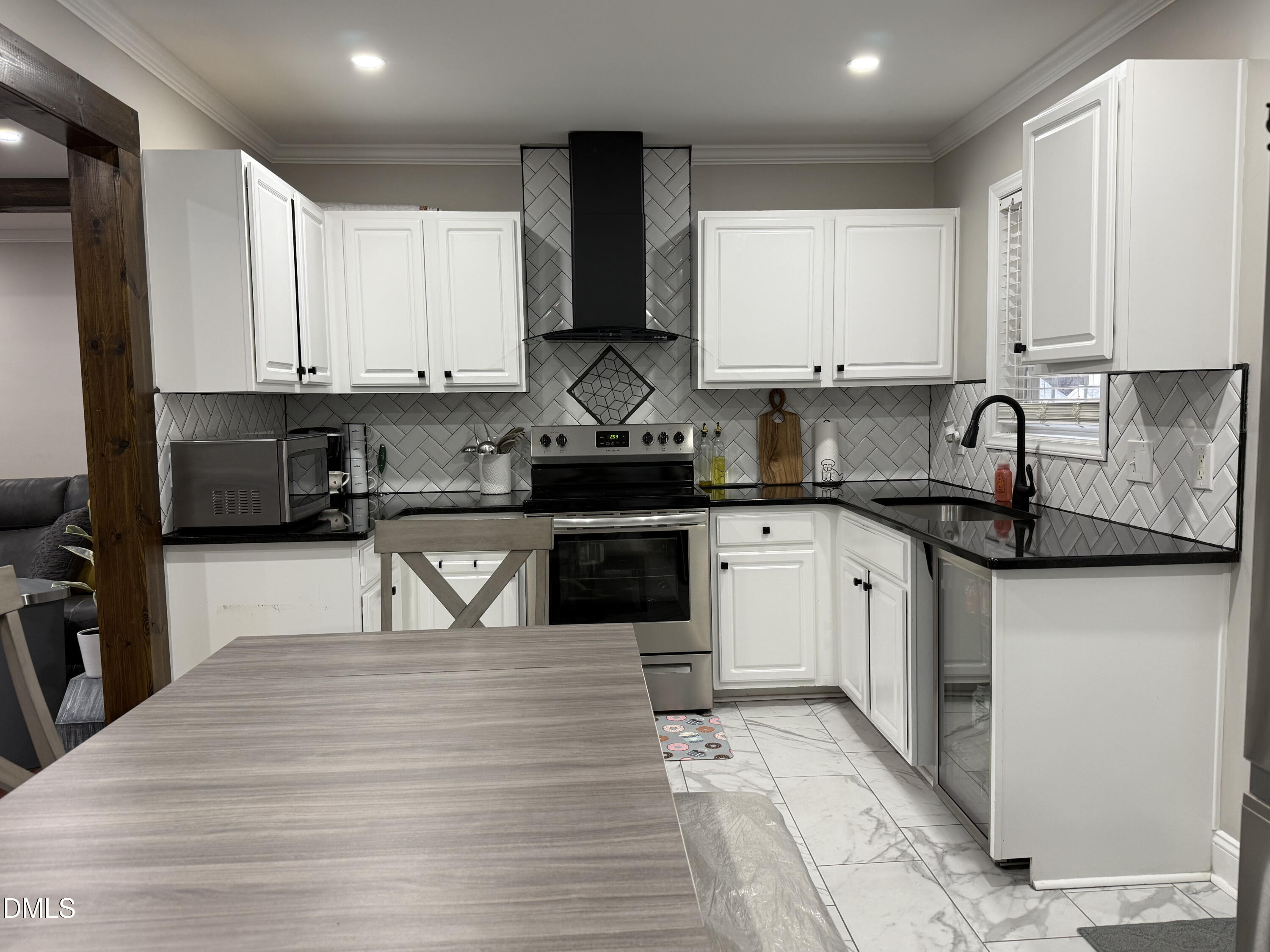 1020 Laurel Leaf Road Zebulon, NC 27597 - Photo 18 of 27 a kitchen with granite countertop a sink a counter top space cabinets and stainless steel appliances