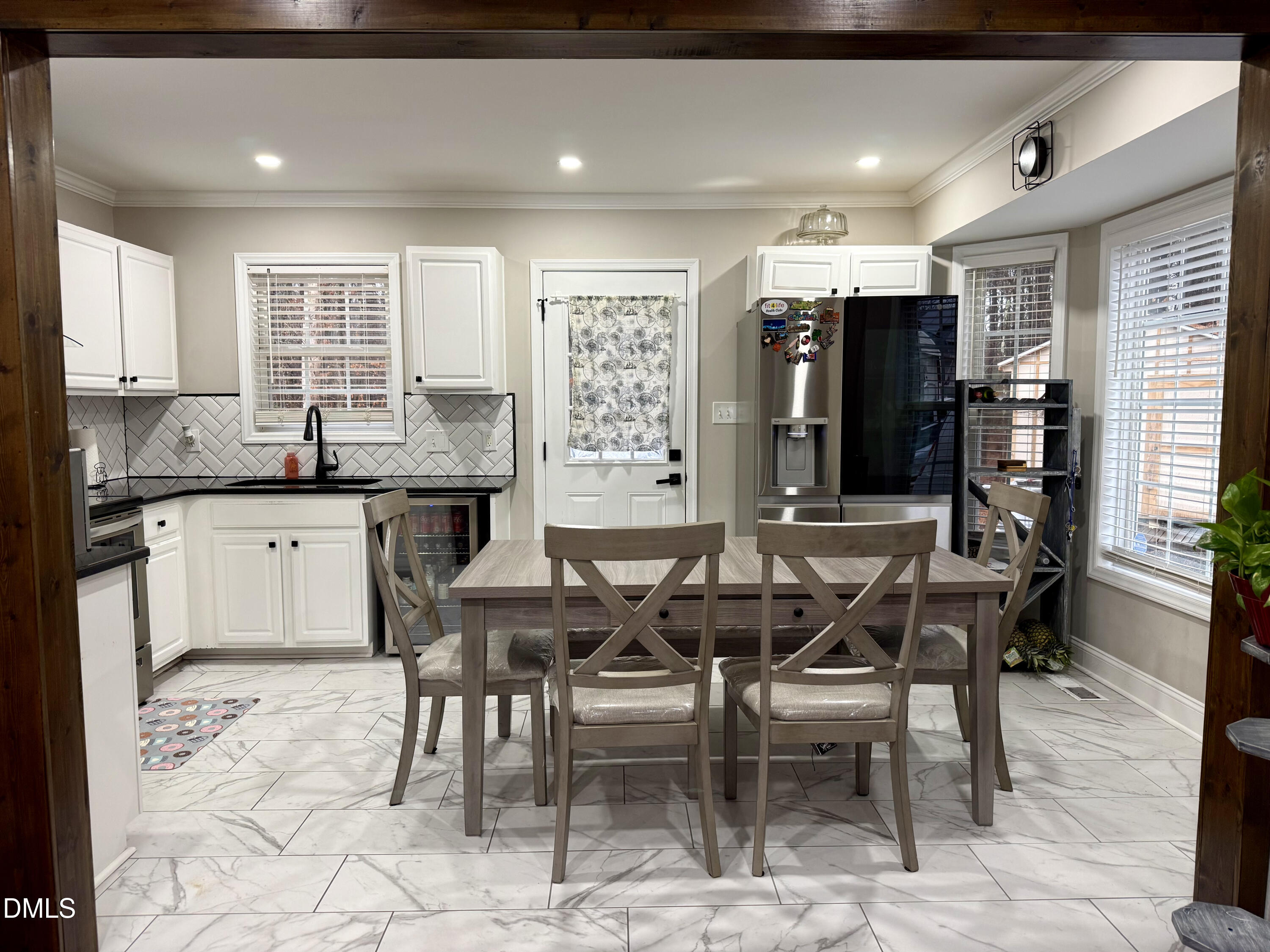 1020 Laurel Leaf Road Zebulon, NC 27597 - Photo 19 of 27 a dining hall with stainless steel appliances kitchen island granite countertop a dining table and chairs
