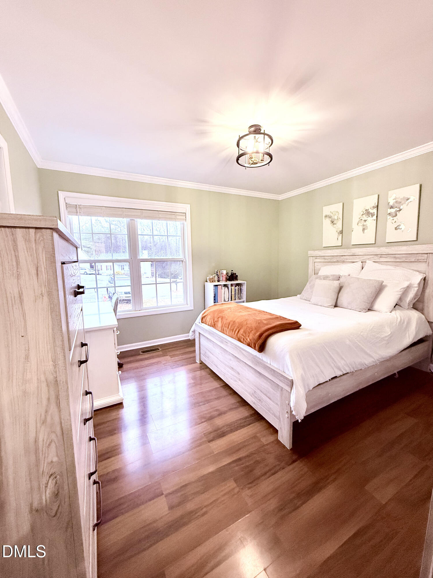 1020 Laurel Leaf Road Zebulon, NC 27597 - Photo 21 of 27 a bedroom with a bed and wooden floor