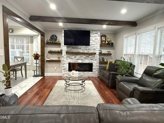 a living room with furniture fireplace and flat screen tv