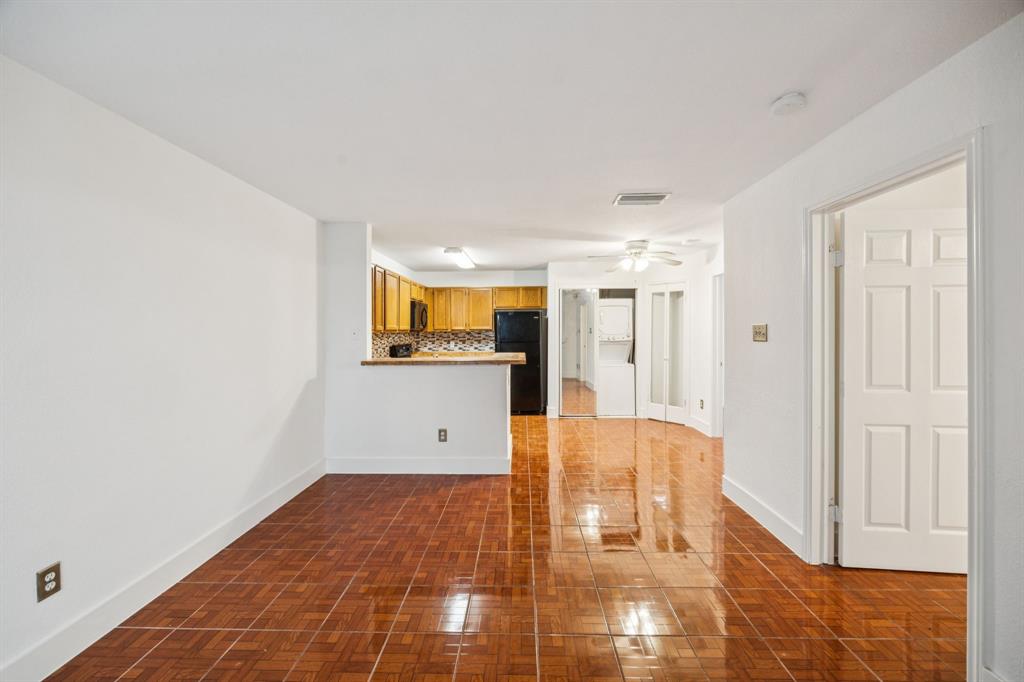 6108 Abrams Road, Unit 410 Dallas, TX 75231 - Photo 2 of 10 a view of a hallway with wooden floor and cabinet