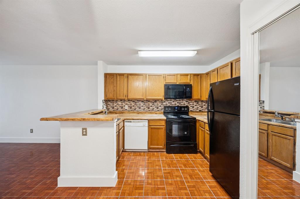 6108 Abrams Road, Unit 410 Dallas, TX 75231 - Photo 4 of 10 a kitchen with a refrigerator sink and stove