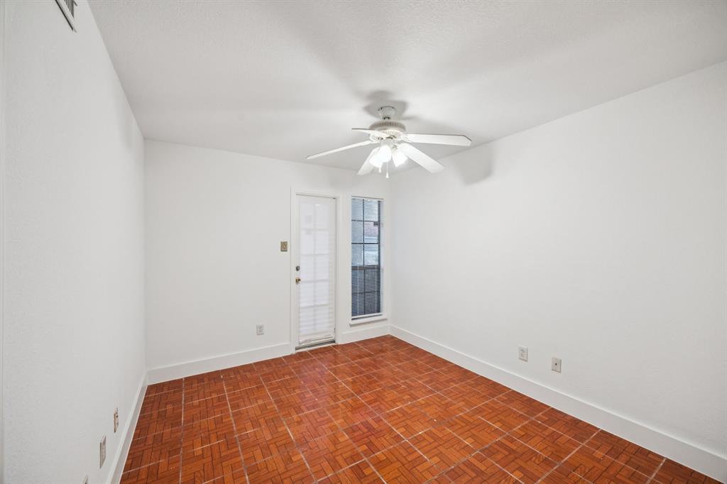 6108 Abrams Road, Unit 410 Dallas, TX 75231 - Photo 5 of 10 an empty room with a chandelier fan and windows